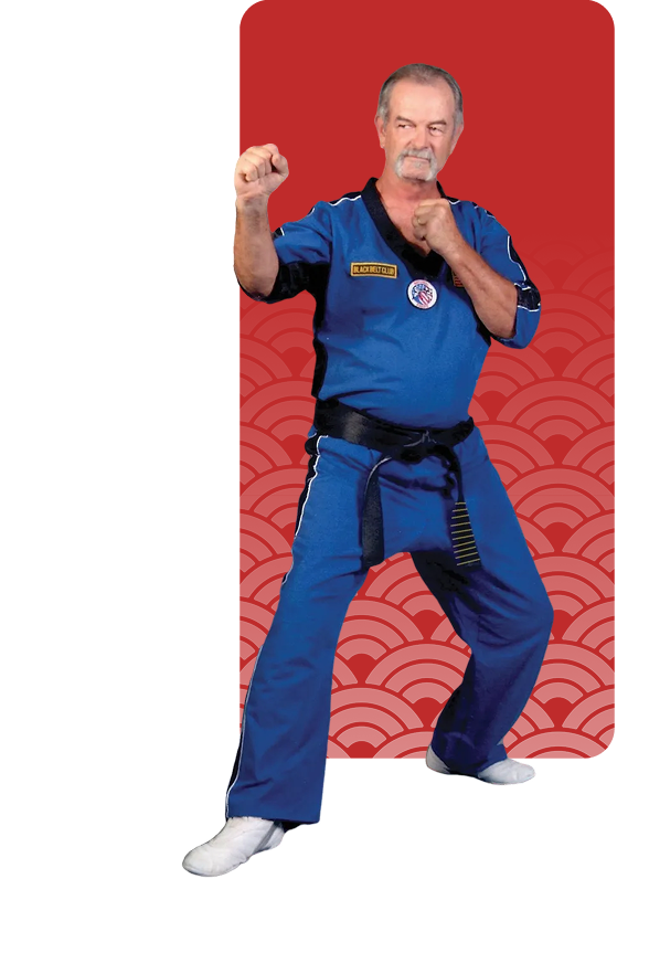 Martial artist in blue gi performing a fighting stance.