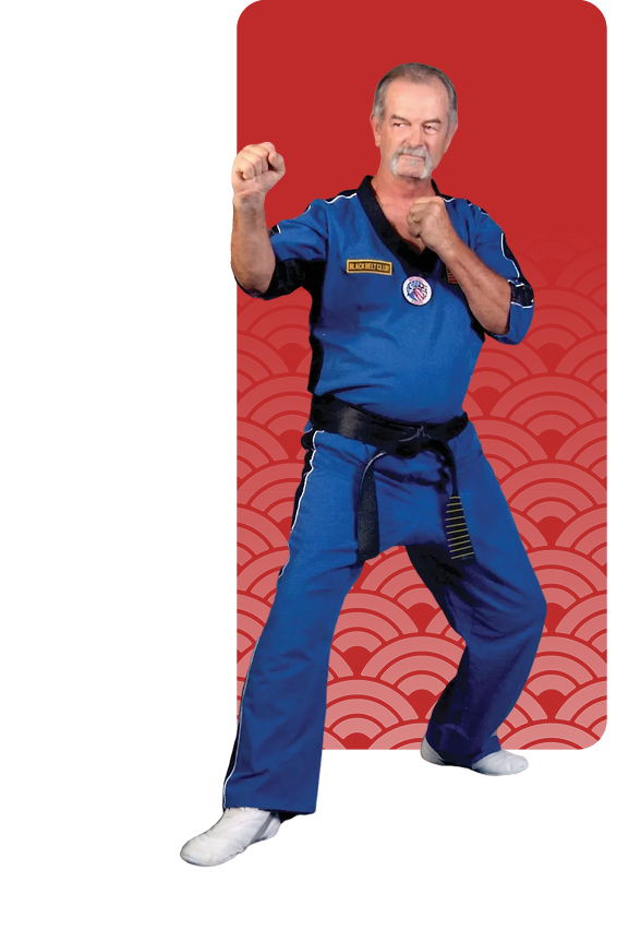 Martial artist in blue gi performing a fighting stance.