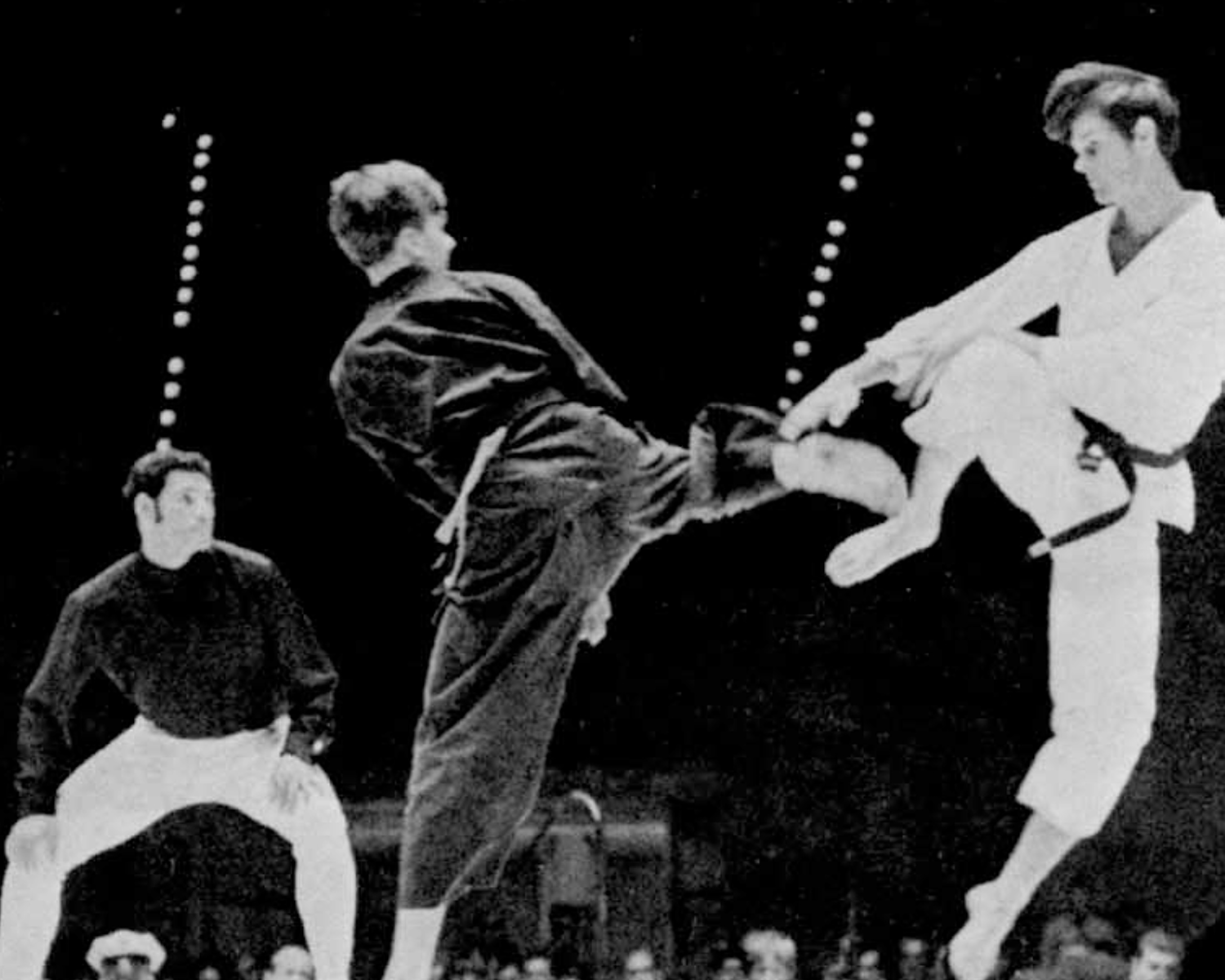 Martial artists demonstrating high kicks during a competition.