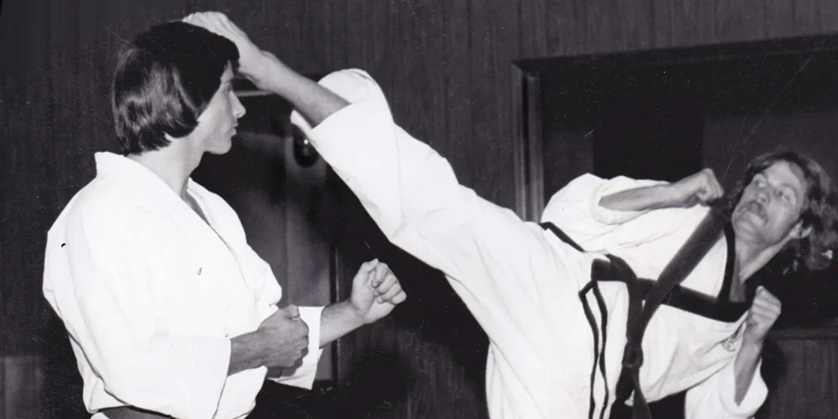 Two karateka engaged in sparring session